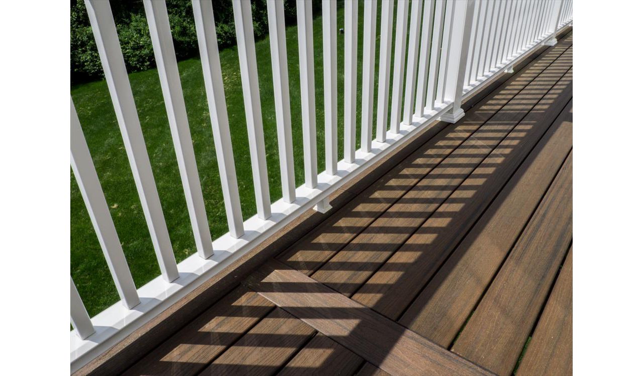 Cantilevered deck with white railings, Redding, CT, Trex Transcend spiced rum