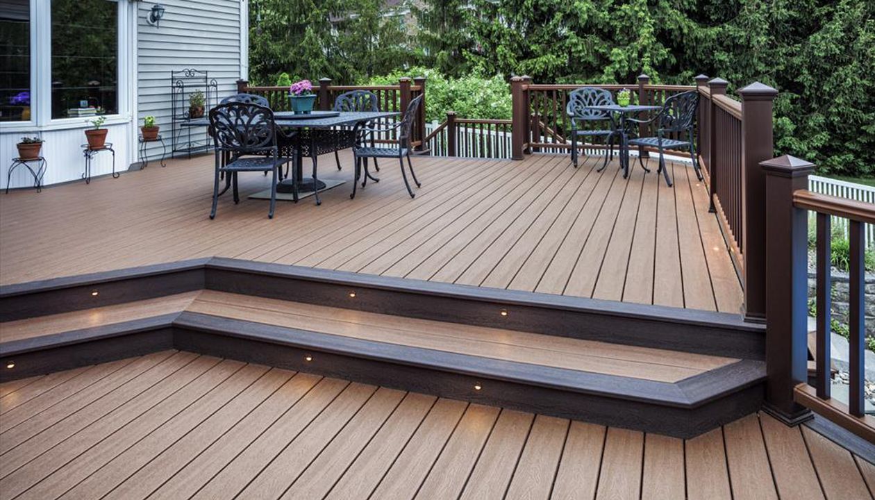 A Vintage Lantern picture frame border as well as riser lights are nice design touches for this tiered Treehouse Trex Transcend outdoor space in Clinton, N.J.