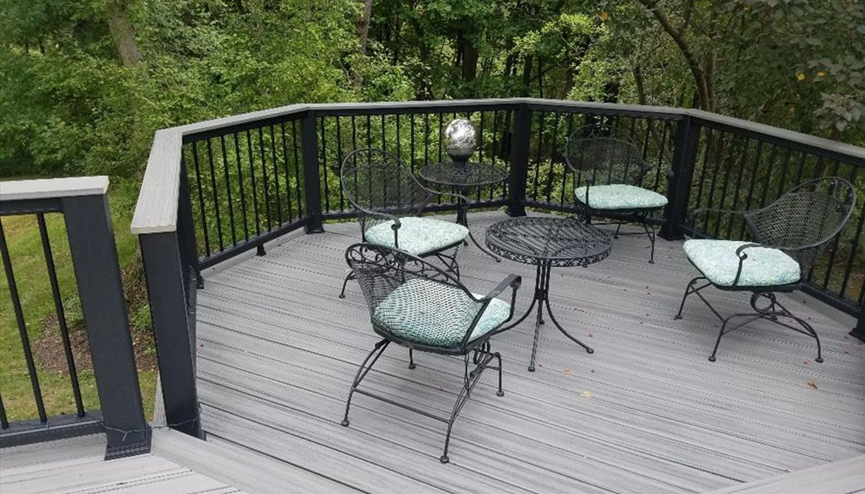 A second look at this deck project features a sunken octagon.This black Transcend railing has the black aluminum balusters and a cocktail rail cap in matching Island Mist.