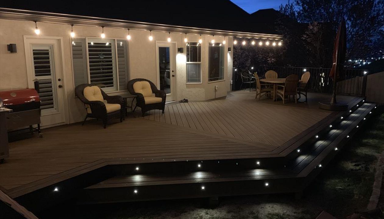 Havana Gold with Spiced Rum boarder. Trex lighting in steps and railing. Utah deck builder