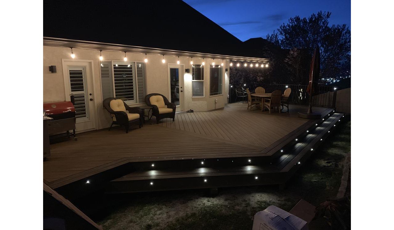 Havana Gold with Spiced Rum boarder. Trex lighting in steps and railing. Utah deck builder