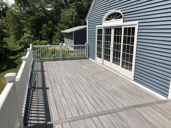 Trex Island Mist decking with white railing and lighted post caps