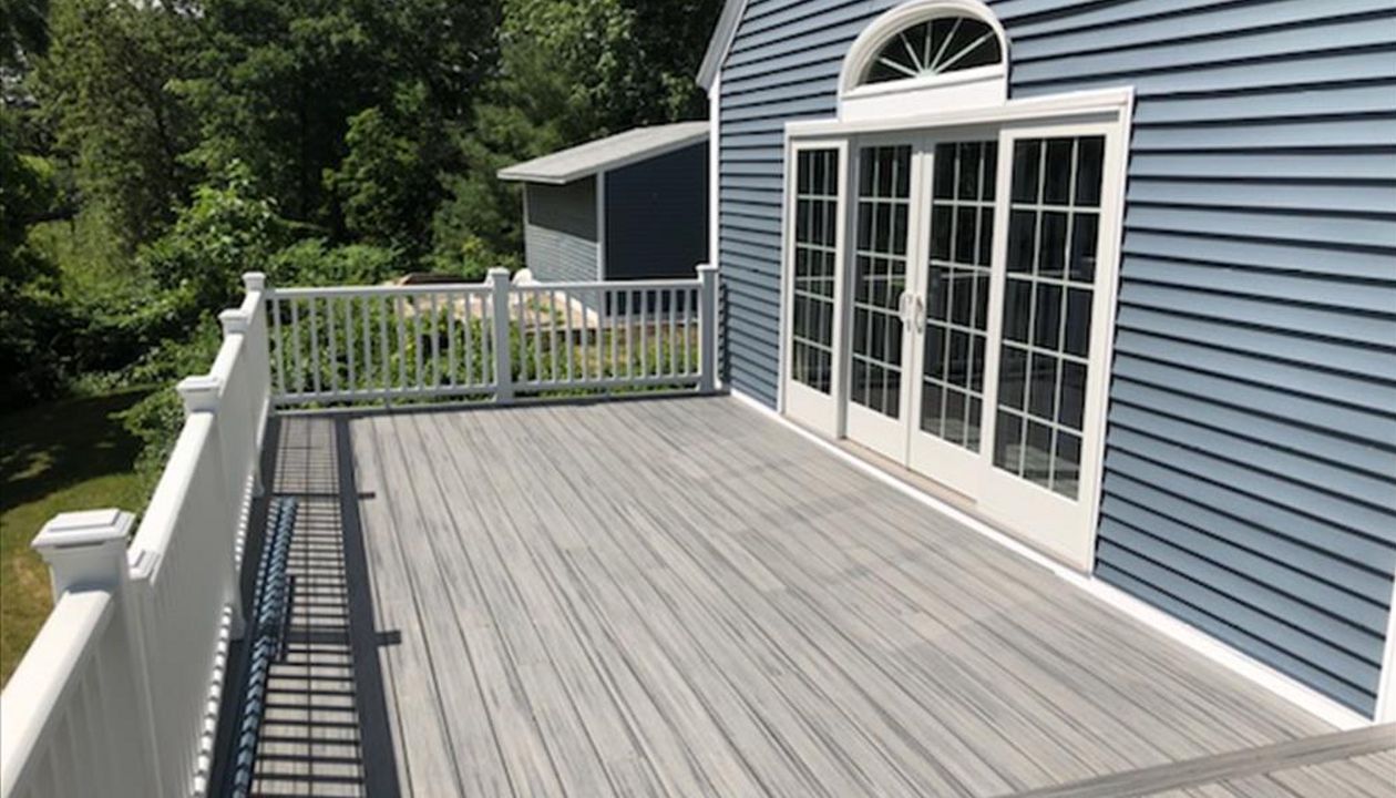 Trex Island Mist decking with white railing and lighted post caps