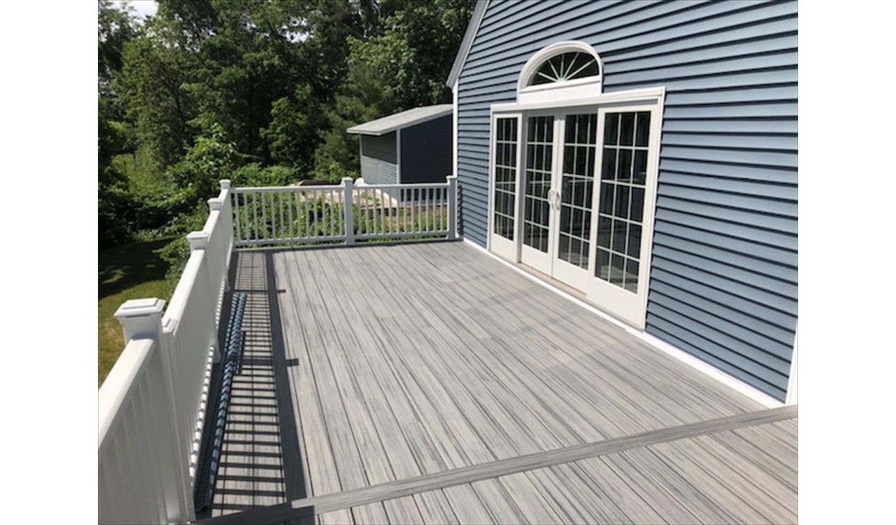 Trex Island Mist decking with white railing and lighted post caps