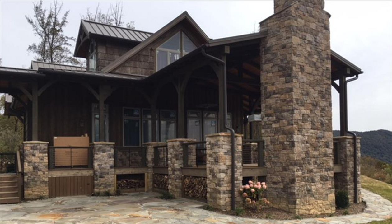 Custom Trex Transcend Havana Gold wood storage areas have both style & function in this custom home.