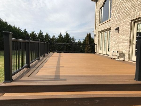 Trex Transcend Tiki Torch deck with Charcoal Black Enhance handrails is a stunning combination