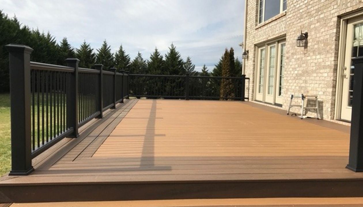 Trex Transcend Tiki Torch deck with Charcoal Black Enhance handrails is a stunning combination