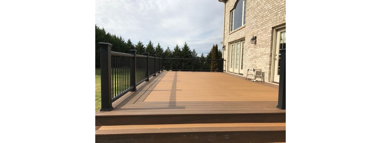 Trex Transcend Tiki Torch deck with Charcoal Black Enhance handrails is a stunning combination