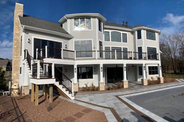 This deck features Trex transcend spice rum as the main decking and drink rail and Trex transcend vintage lantern for the picture frame and middle divider. It has Trex transcend railing that consists of white post sleeves, vintage lantern top/bottom rail.