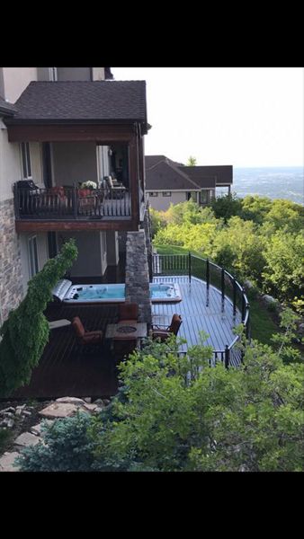 curved woodland brown trex deck with built in hottub