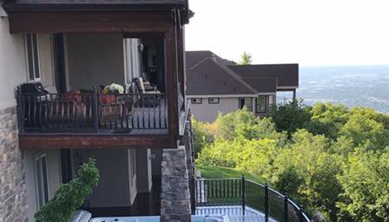 curved woodland brown trex deck with built in hottub