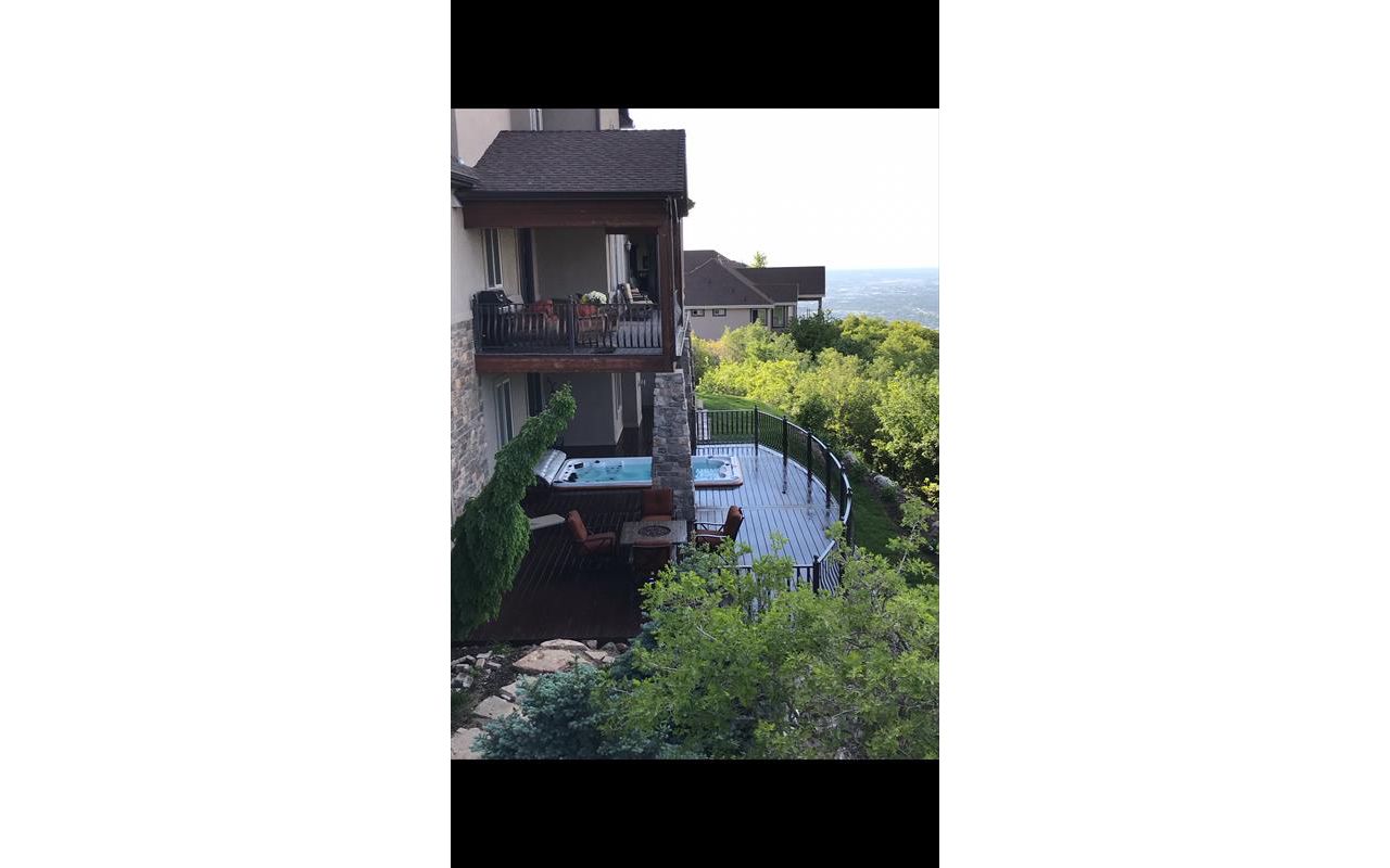 curved woodland brown trex deck with built in hottub