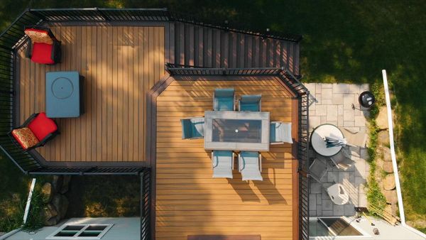 Two tiers create well defined areas without a total separation. Trex lighting adds additional ambiance and safety at night.