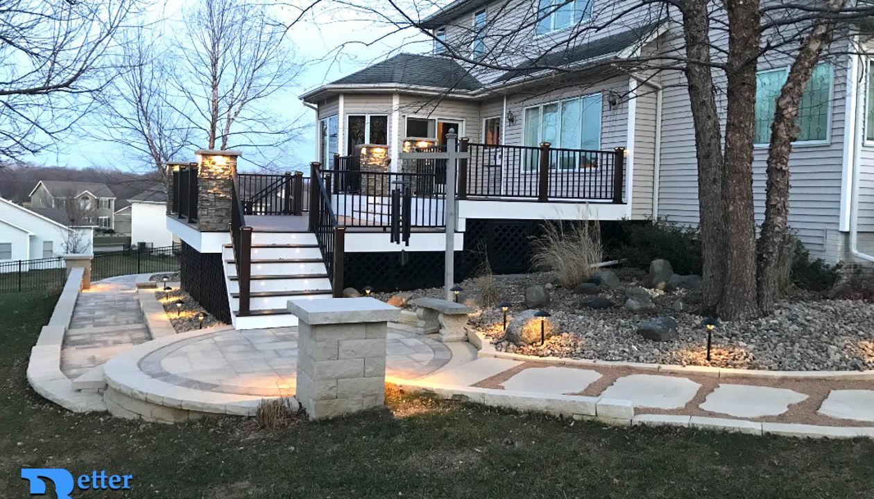 New landscaping and deck with Spiced Rum, Transcend Posts, Signature railing, and Trex lighting - Better Builders of Iowa - Deck project in Johnston, IA