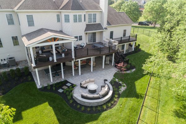 Trex Deck with Spiced Rum Decking, Trex Transcend Railing, Custom Curve, Roof, and Patio