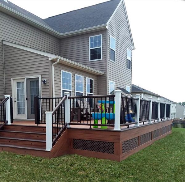 Tiki Torch decking with Vintage Lantern border, White post, vintage lantern rails w/ black pickets. Trex post and riser lighting.