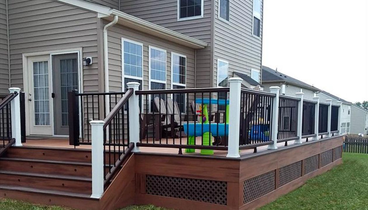Tiki Torch decking with Vintage Lantern border, White post, vintage lantern rails w/ black pickets. Trex post and riser lighting.