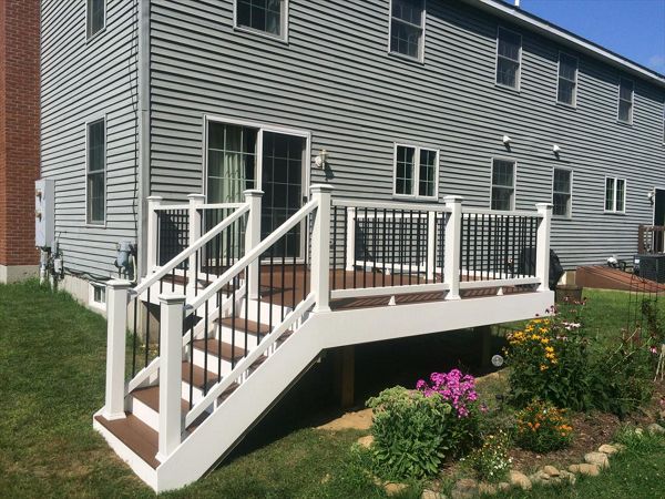 Select saddle decking, pvc trimboard risers and fascia, Trex enhance rails with black pipe balusters