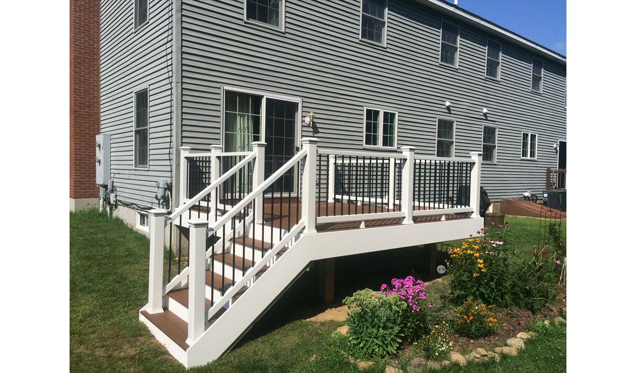 Select saddle decking, pvc trimboard risers and fascia, Trex enhance rails with black pipe balusters