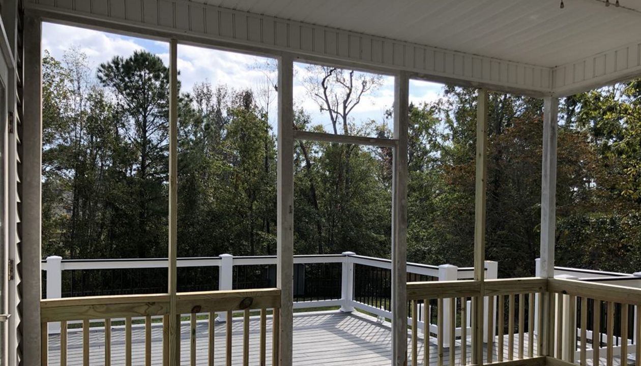 Trex deck flows from porch with Rain Escape below deck