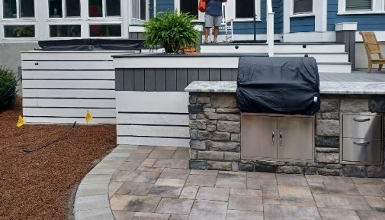 This new deck & hardscape project features Trex Select Pebble Grey decking with a Winchester Grey picture frame for an upgraded visual