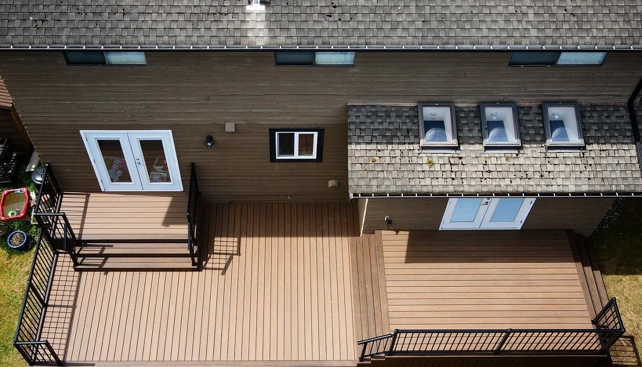Toasted Sand field and risers with Spiced Rum bordering, lighting package, and aluminum railings.