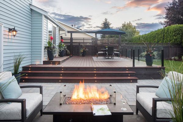 Trex Transcend Lava Rock with LED deck lighting, fire table and topless glass railings. Project location Pitt Meadows BC