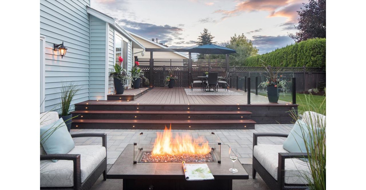 Trex Transcend Lava Rock with LED deck lighting, fire table and topless glass railings. Project location Pitt Meadows BC