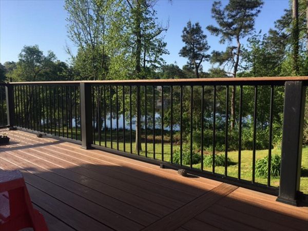 Trex Transcend Charcoal Black Rails with Tiki Torch cocktail rails allow this homeowner to see the wonderful pond and landscape