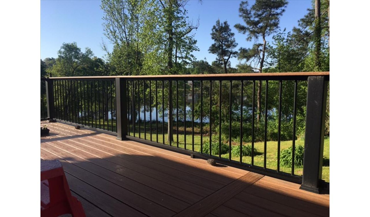 Trex Transcend Charcoal Black Rails with Tiki Torch cocktail rails allow this homeowner to see the wonderful pond and landscape
