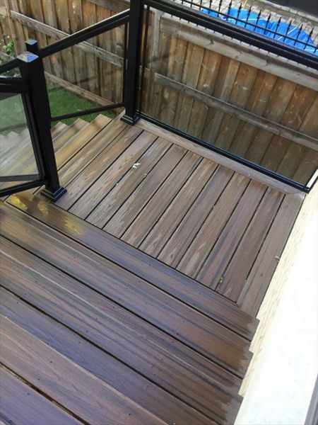 Trex Tropical Spiced Rum custom made COMPOSITE deck with glass and aluminum railing. The deck built in Toronto, Mississauga, Scarborough, Etobicoke, North York, Markham, Richmond Hill, Thornhill, Vaughan