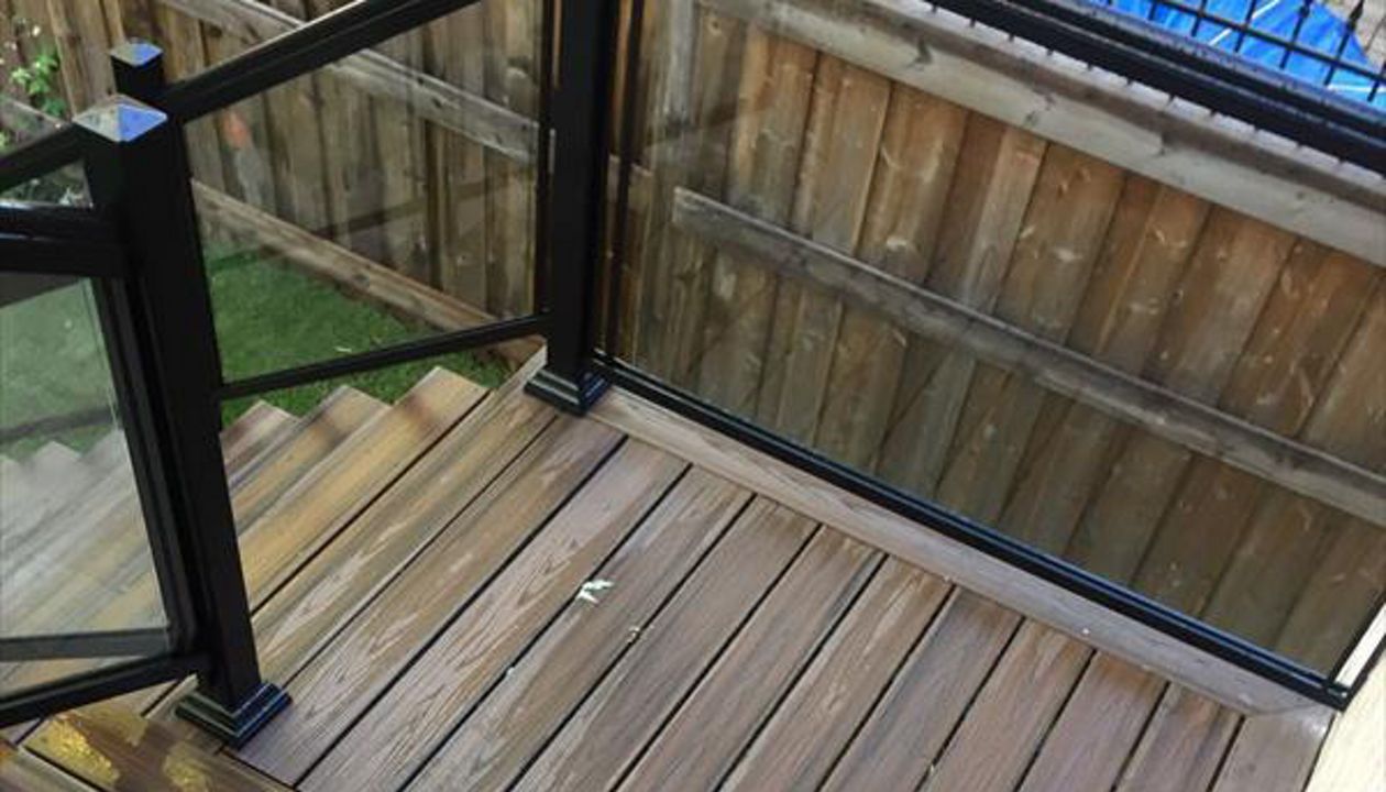 Trex Tropical Spiced Rum custom made COMPOSITE deck with glass and aluminum railing. The deck built in Toronto, Mississauga, Scarborough, Etobicoke, North York, Markham, Richmond Hill, Thornhill, Vaughan