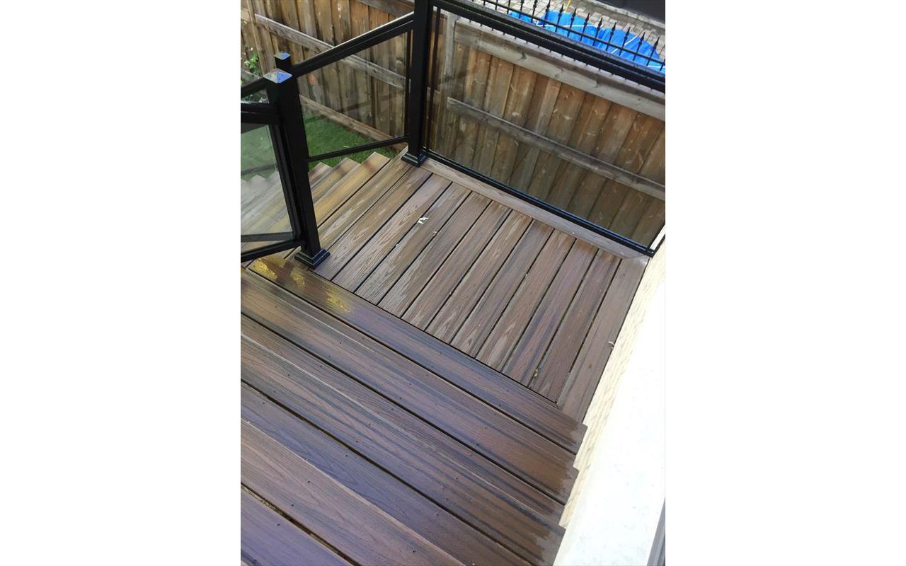 Trex Tropical Spiced Rum custom made COMPOSITE deck with glass and aluminum railing. The deck built in Toronto, Mississauga, Scarborough, Etobicoke, North York, Markham, Richmond Hill, Thornhill, Vaughan