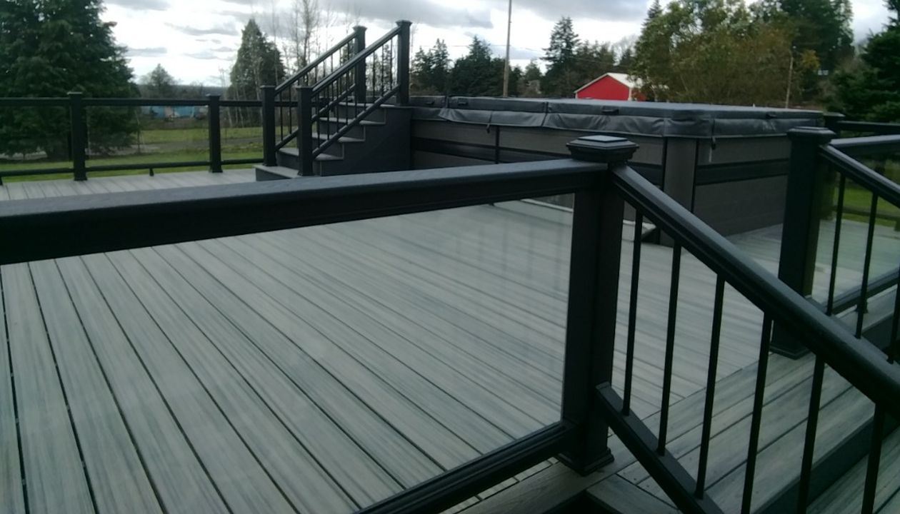Glass infill with lighted postcaps on swim spa deck