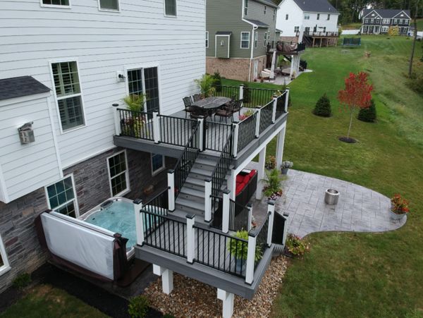 Island Mist decking with Signature railing over stamped concrete patio with hot tub