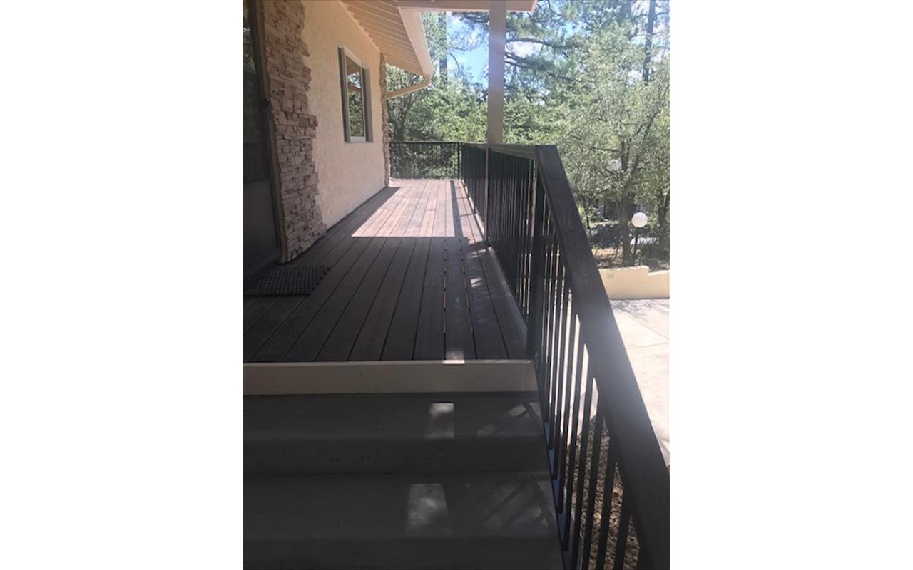 Prescott AZ. Lava Rock with groove, hidden clips. Trex joist tape. 2x4 Lava Rock railing cap.