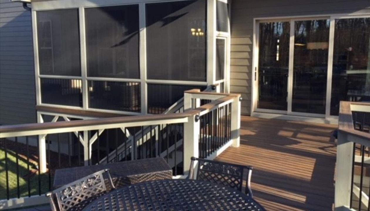 This Trex Transcend Spiced Rum deck in Wake Forest, NC leads nicely into this screened porch area.