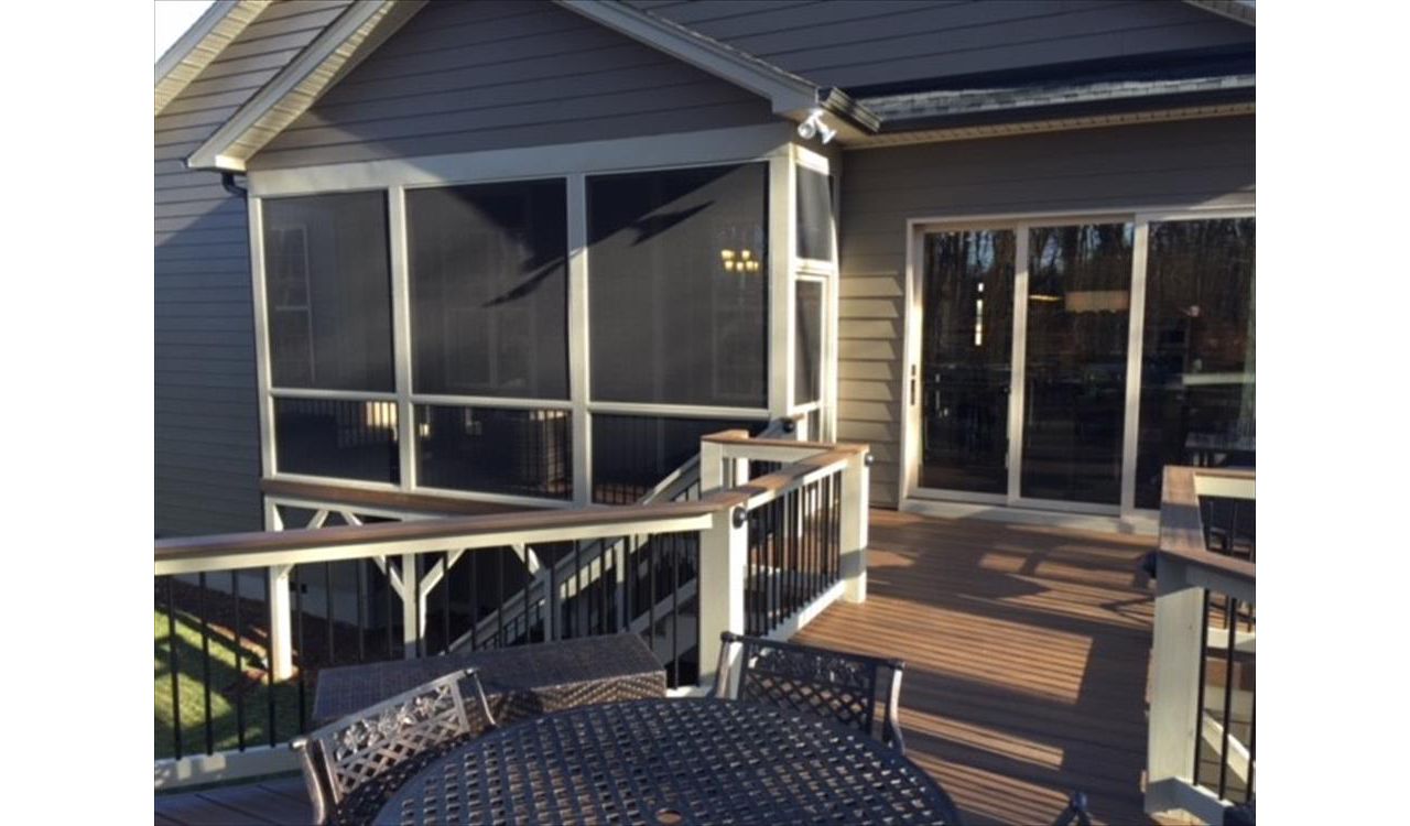 This Trex Transcend Spiced Rum deck in Wake Forest, NC leads nicely into this screened porch area.