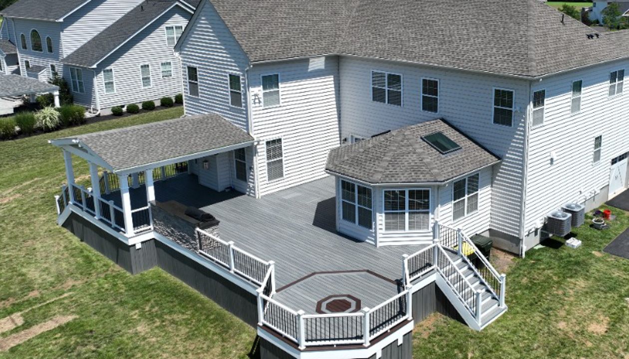 Trex Deck with Island Mist Decking, Trex Transcend Railing, Custom Roof, and Outdoor Kitchen
