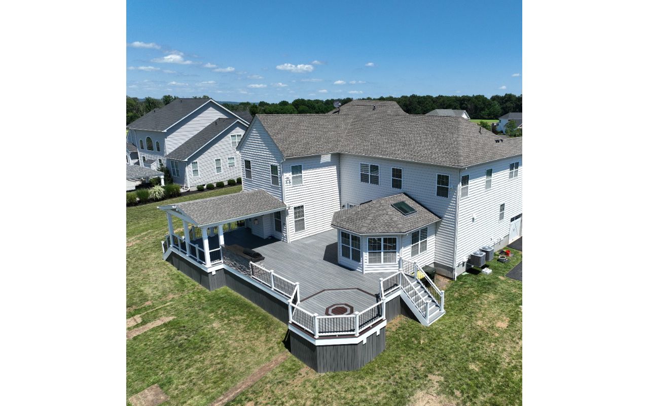 Trex Deck with Island Mist Decking, Trex Transcend Railing, Custom Roof, and Outdoor Kitchen
