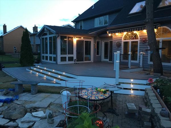 Transcend decking in Island Mist with a double picture frame and stair lighting. Signature Black handrail with white posts and lighted post caps.