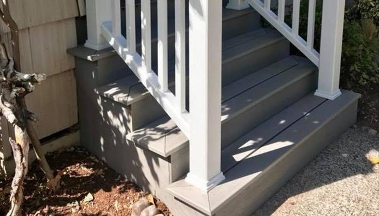 Gravel Path stairs closed off by classic vertical design. The Classic white Transcend Rail is a nice compliment