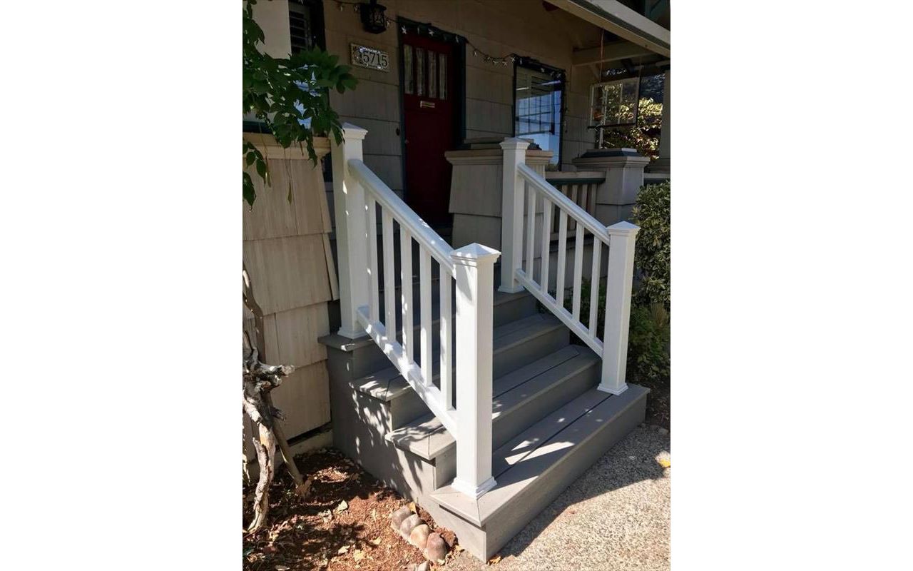 Gravel Path stairs closed off by classic vertical design. The Classic white Transcend Rail is a nice compliment