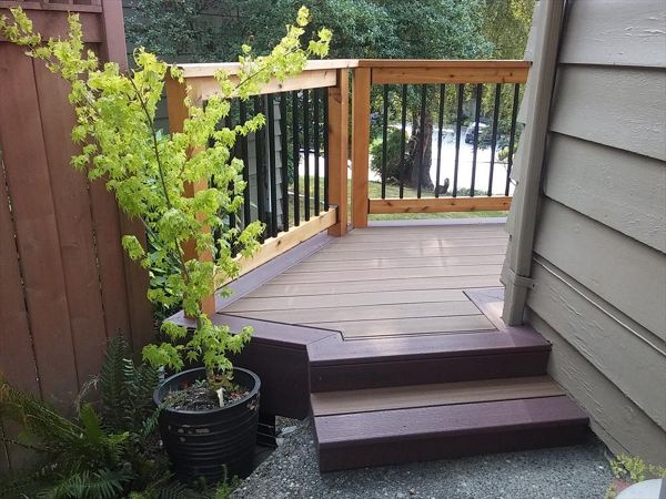 Trex Contour Torino Brown with Moroccan Red border with stained tight knot cedar rails and black aluminum balusters.