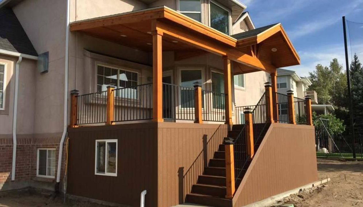 Composite saddle Trex with matching skirting, under deck storage with door and window, Trex rainscape, Gable over entire deck