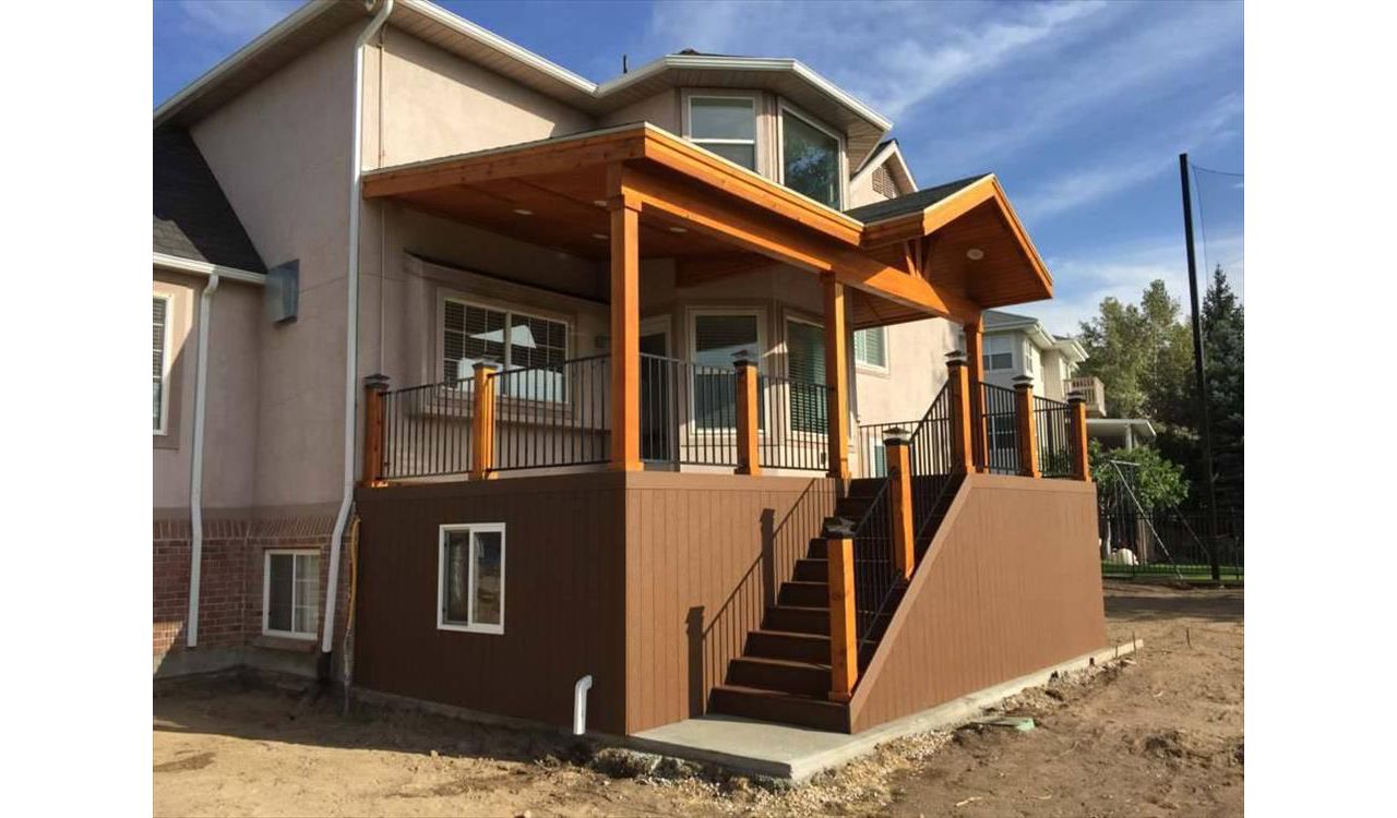 Composite saddle Trex with matching skirting, under deck storage with door and window, Trex rainscape, Gable over entire deck