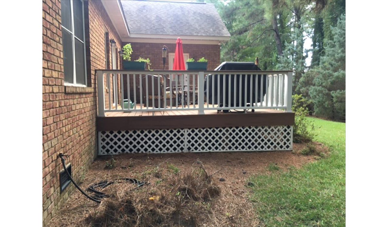 Trex Transcend Tiki Torch deck looks great against this brick home.