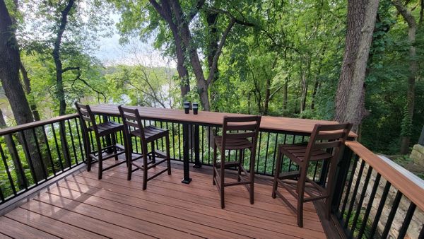 Custom bar top with Trex Tiki Torch decking, Trex railing, and Trex furniture