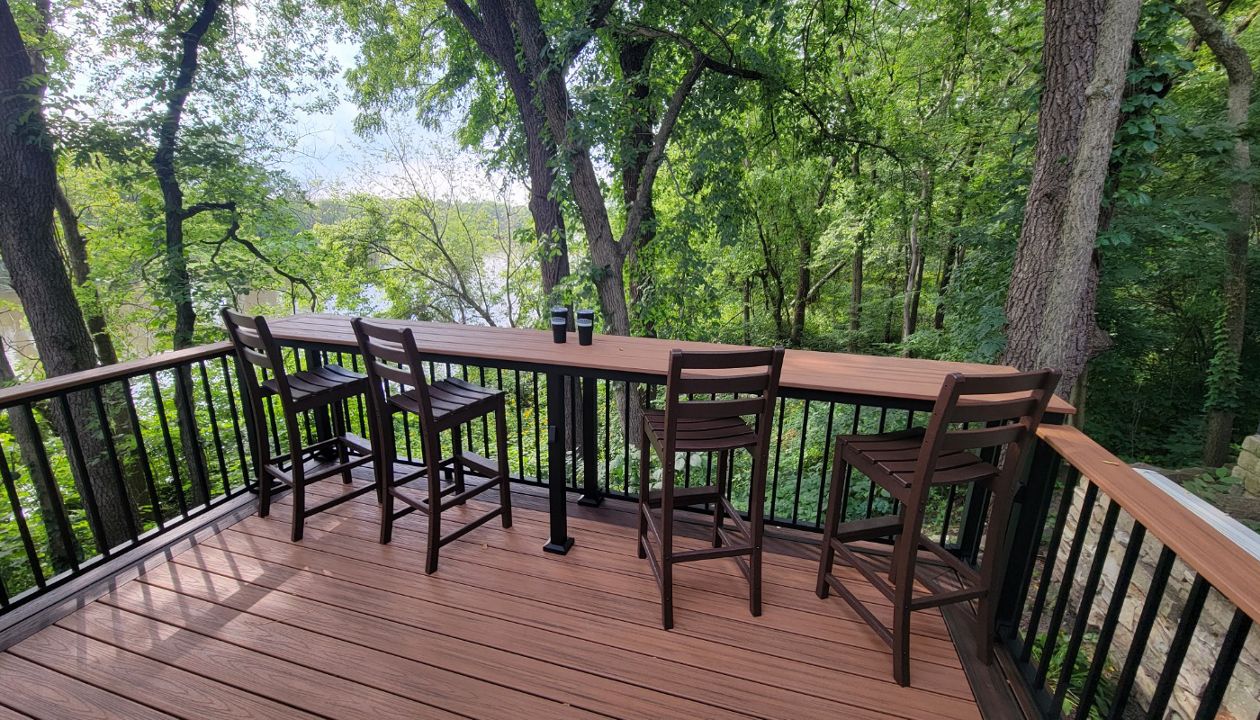 Custom bar top with Trex Tiki Torch decking, Trex railing, and Trex furniture