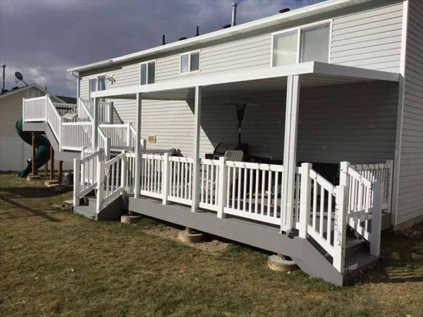 Multi level composite pebble grey Trex decking with matching fascia 8x8 upper level and 20x10 lower deck.